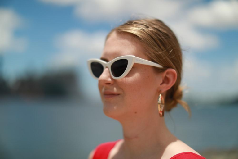 A woman standing outdoors after getting autism coaching