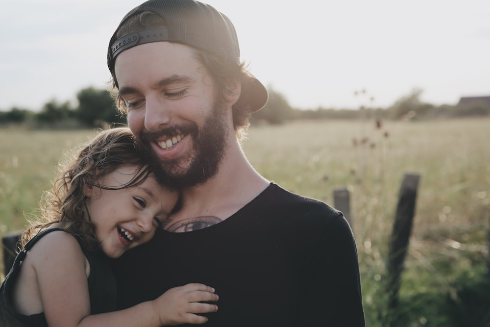 a man holding his daughter.